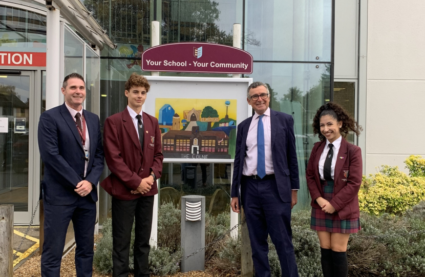 Bernard outside Colne community school & college with headteacher and two pupils