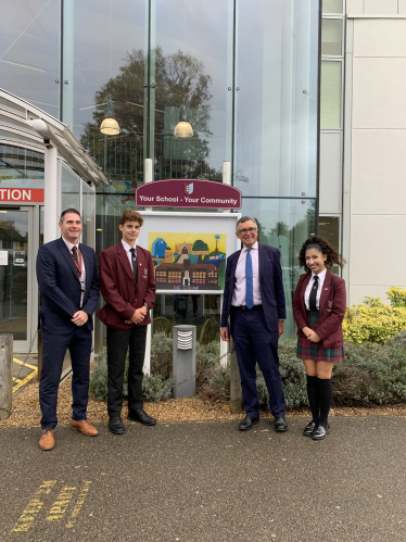 Bernard outside Colne community school & college with headteacher and two pupils